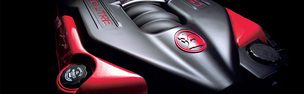 Red engine cover under a vehicle bonnet